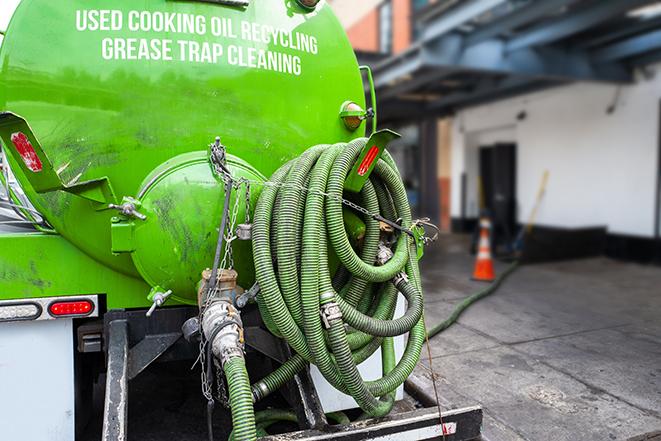 a service truck pumping grease from a restaurant's grease trap in Pacific Grove